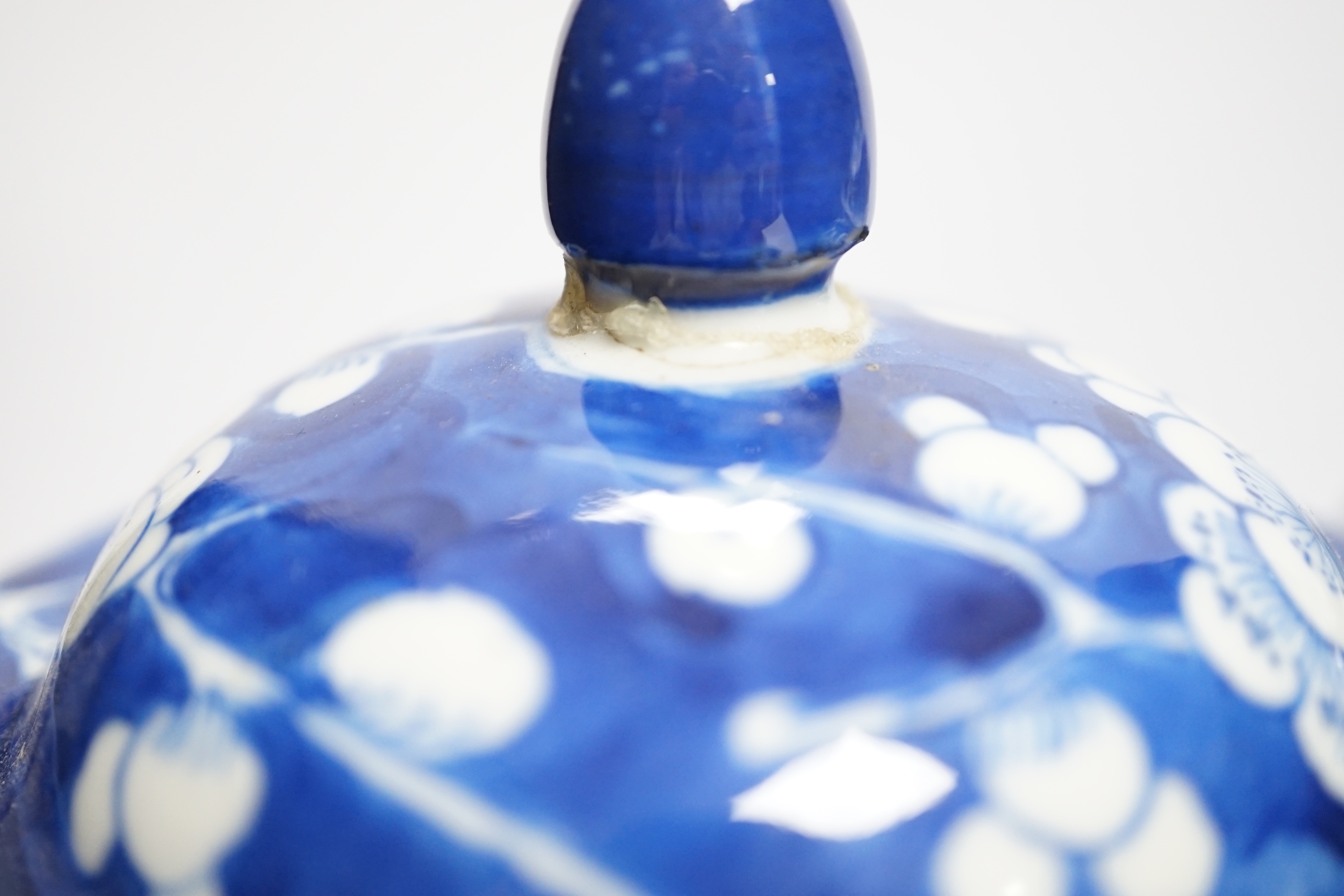 A near pair of 19th century Chinese blue and white prunus jars and covers, 26cm high